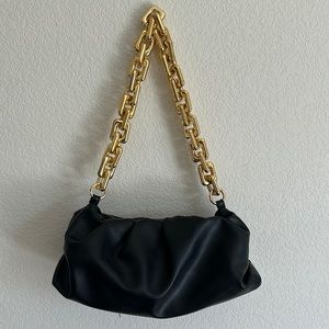 Black shoulder bag with gold chain handle